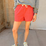 Buttermelon Red Checkered Boxer Shorts styled with a Sunny Somewhere graphic sweatshirt for summer from Shop Estilo.